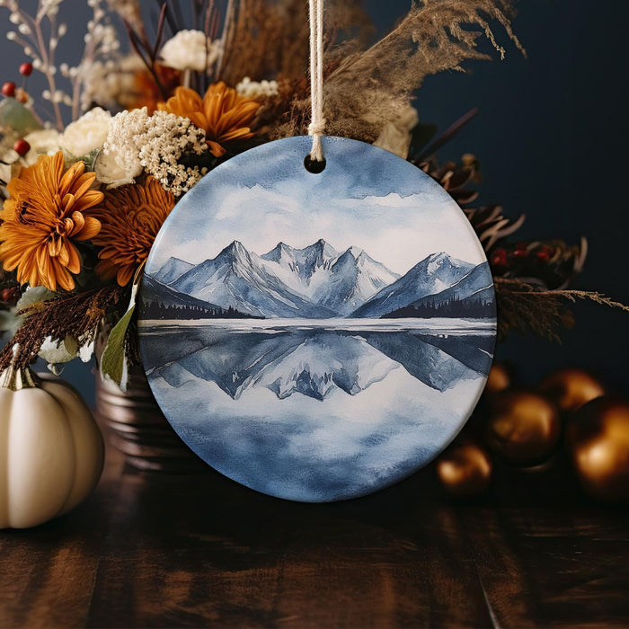a ceramic ornament with a picture of a mountain range on it