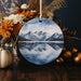 a ceramic ornament with a picture of a mountain range on it