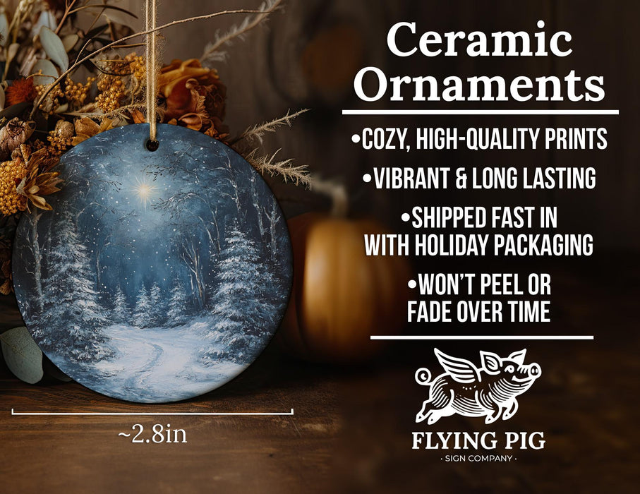 a ceramic ornament with a snowy forest scene
