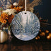 a christmas ornament with a picture of a snowy forest