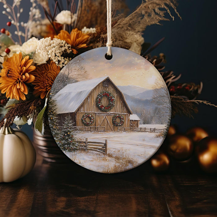 a christmas ornament with a picture of a barn