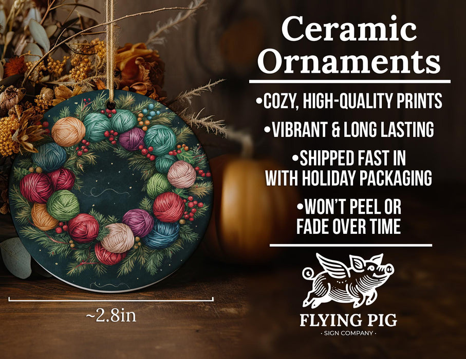 a ceramic ornament with colorful balls of yarn on it