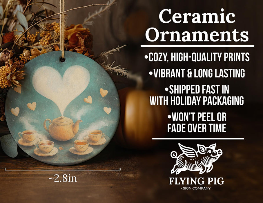 a ceramic ornament with a teapot and heart on it