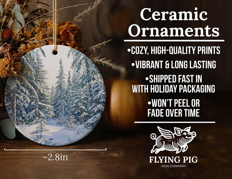 a ceramic ornament with a snowy forest scene