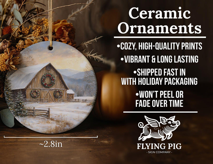 a ceramic ornament with a barn in the snow
