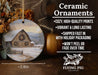 a ceramic ornament with a barn in the snow