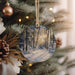 a christmas ornament hanging from a christmas tree