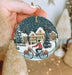 a person holding a christmas ornament with a bicycle on it