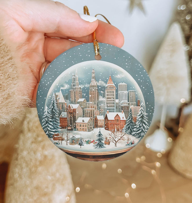 a person holding a christmas ornament in their hand