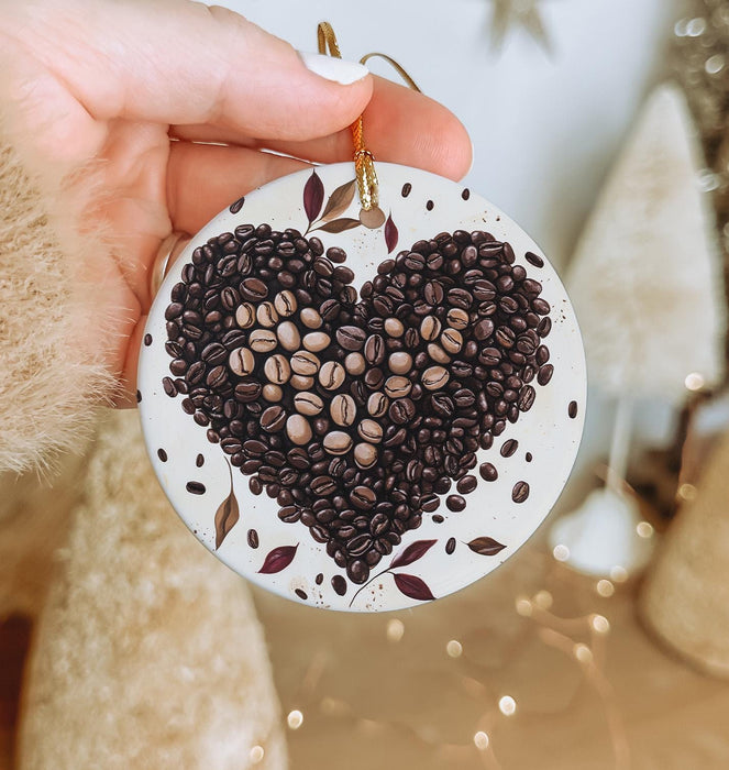 a person holding a ceramic ornament with coffee beans in the shape of a