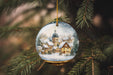 a glass ornament hanging from a christmas tree