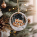 a christmas ornament with a picture of two foxes on it