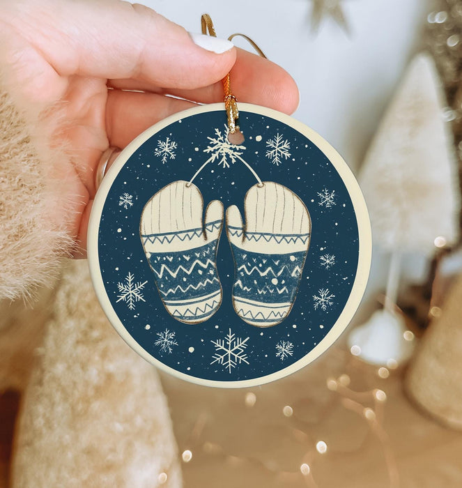 a hand holding a christmas ornament with a pair of slippers on it