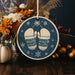 a christmas ornament with a pair of mittens on it