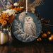 an ornament with a picture of an owl on it