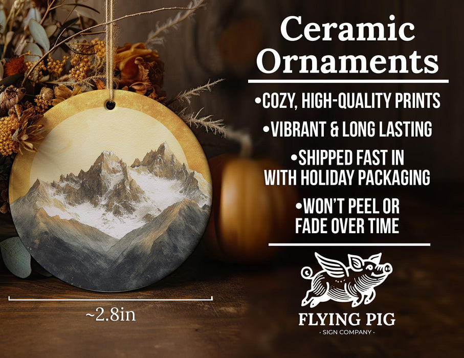 a ceramic ornament with a mountain scene on it