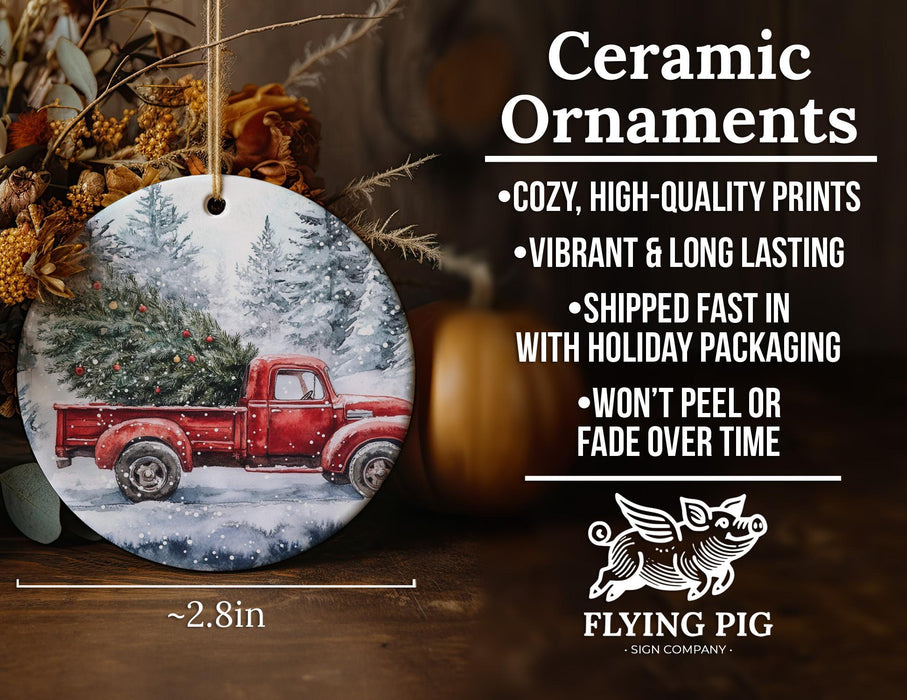 a christmas ornament with a red truck in the snow