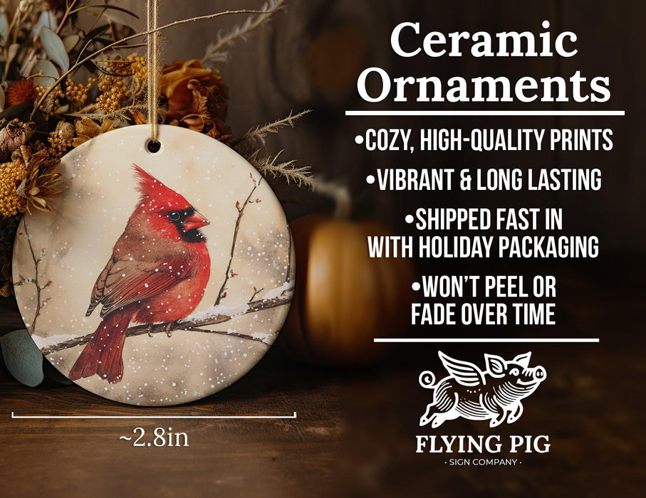 a ceramic ornament with a cardinal sitting on a branch