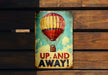 a sign that says up and away with a hot air balloon