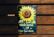 a metal sign with a sunflower painted on it
