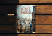 a sign on a wooden bench that says visit paris