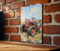 a painting of a red tractor on a brick wall
