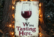 a wine tasting sign with a glass of wine