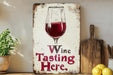 a wooden sign with a glass of wine on it