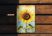 a picture of a sunflower on a wooden bench