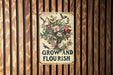 a sign on a wooden wall that says grow and flourish