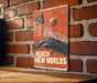 a sign on a brick wall that says reach new world