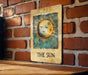 a picture of a sun on a brick wall