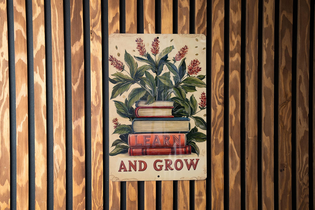 a sign on a wooden wall that says learn and grow