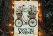 a sign that says enjoy the journey with a bicycle and flowers