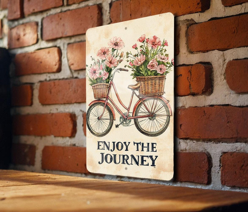 a sign that says enjoy the journey on a brick wall