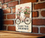 a sign that says enjoy the journey on a brick wall