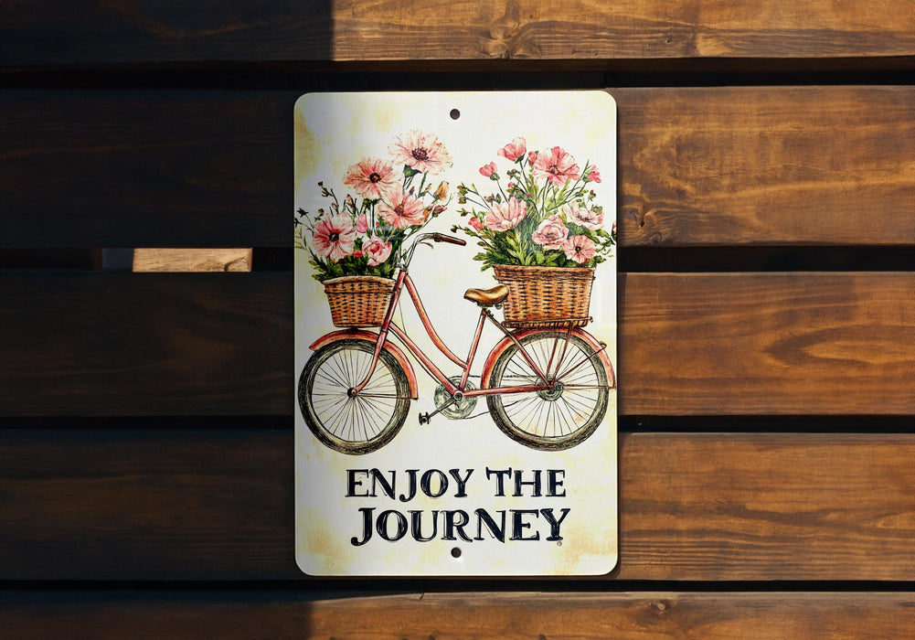 a sign that says enjoy the journey with flowers on a bicycle