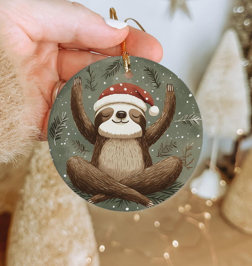 a hand holding a christmas ornament with a slotty on it