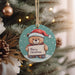 a christmas ornament hanging from a christmas tree