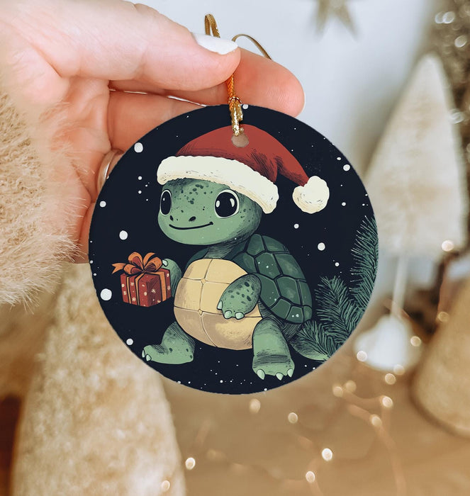 a person holding a christmas ornament with a turtle on it