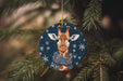 a christmas ornament with a giraffe wearing a scarf