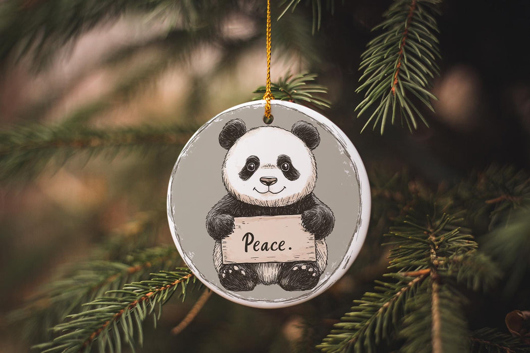 a panda bear ornament hanging from a christmas tree
