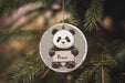 a panda bear ornament hanging from a christmas tree