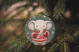 a christmas ornament with an elephant wearing a sweater