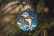 a dolphin ornament hanging from a christmas tree