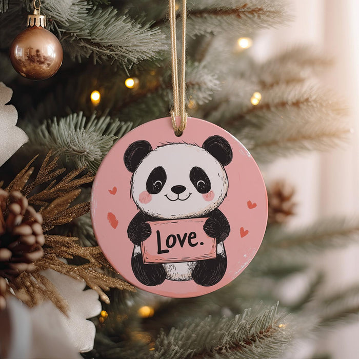 a panda bear ornament hanging from a christmas tree