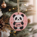 a panda bear ornament hanging from a christmas tree