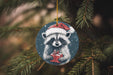 a raccoon ornament hanging from a christmas tree