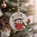 a raccoon ornament hanging from a christmas tree