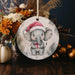 a christmas ornament with an elephant wearing a santa hat